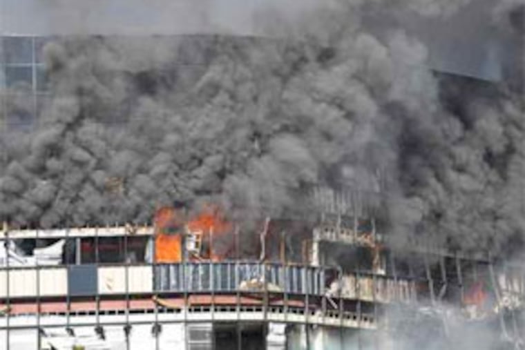 Smoke billows from an office building in Austin, Texas, after a small plane crashed into it. The pilot, Joseph A. Stack, 53, was presumed dead, and at least 13 people were injured. On a Web site, he wrote: "I have had all I can stand." (Trey Jones / Associated Press)