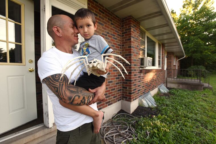 Carlos Diaz, left, is shown holding his son Carter Diaz, right, at his home in Quakertown.