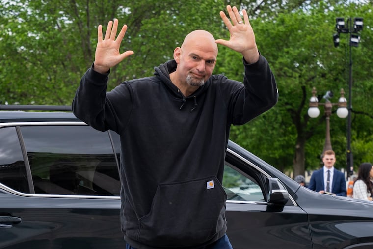 U.S. Sen. John Fetterman waves to members of the media. The Pennsylvania senator voted no on the recent legislation to raise the debt ceiling.