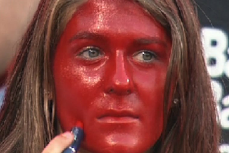 A woman paints her face with lipstick during a Phillies-Mets game at Citizens Bank Park on Aug. 28, 2012. (MLB.com)