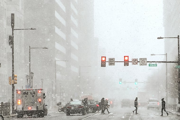 Pedestrians cross at 17th and JFK in Center City during a snow squall in January. Not much more snow fell all winter around here. Could this be a repeat?