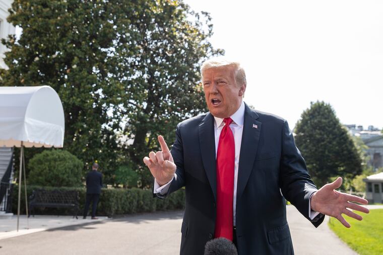 President Donald Trump speaks with reporters before departing on Marine One on the South Lawn of the White House on Tuesday.