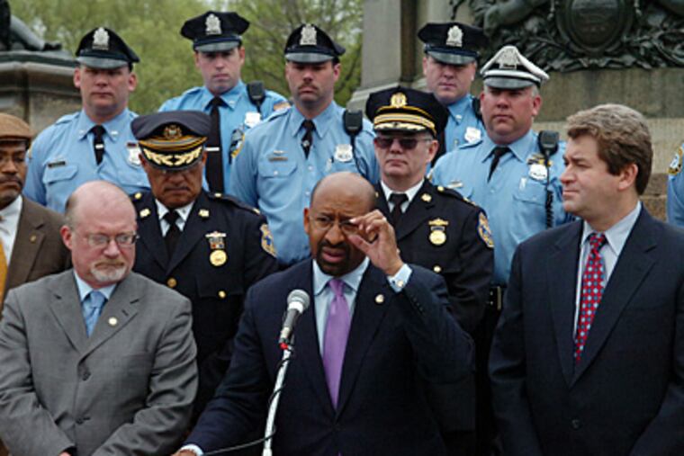 Mayor Michael Nutter speaks during a press conference yesterday where he signed legislation banning the use of cell phones while driving. (Sarah J. Glover / Staff Photographer)