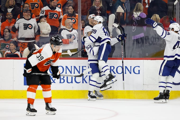 Toronto Maple Leafs right wing Easton Cowan (center) celebrates his overtime goal with teammate Nicholas Robertson on Thursday night.