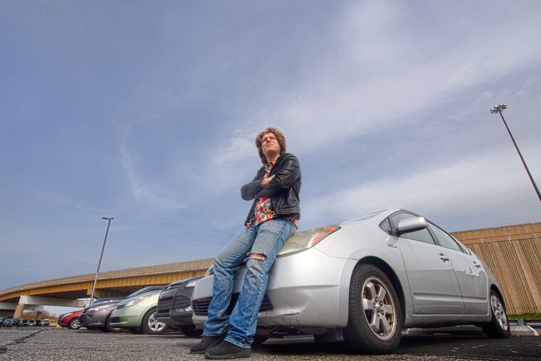 Vincenzo Spallino, Lyft driver, waits waits for customers at the Uber/Lyft lot in Philadelphia International Airport, Wednesday, March 18, 2020.