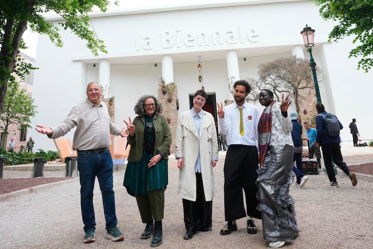 From left, Venice Biennale Art curators, Siddhartha Mitter, Rasha Salti Gabe Beckhurst Feijoo, Rory Tsapayi, and Marie Helene Pereira pose in front of the main entrance at the Venice 2026 Biennale Art, in Venice, Italy, Tuesday, May 5, 2026.