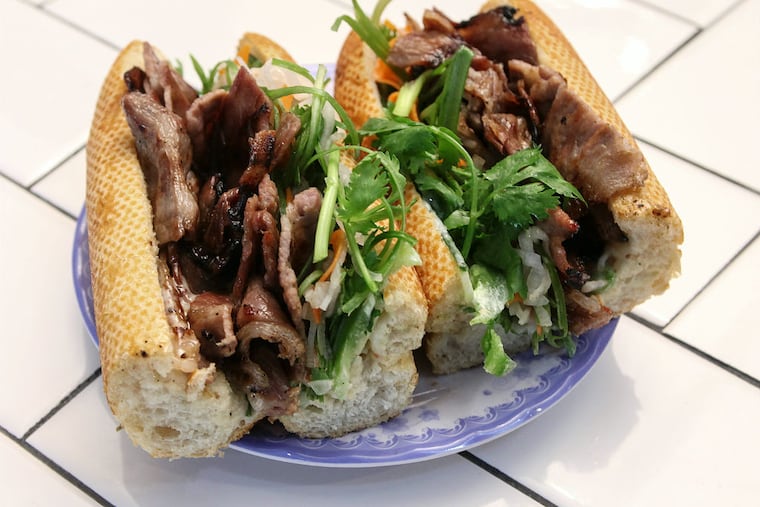 Bánh mì filled with caramelized pork, lemongrass chicken thighs, and pork sausage patties at Same Same. (Steven M. Falk./Staff Photographer)