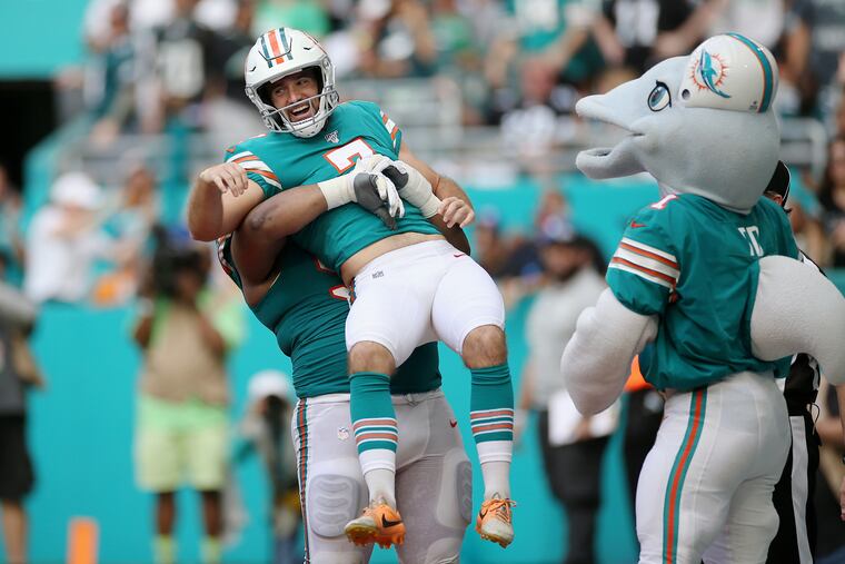 Miami Dolphins defensive tackle Christian Wilkins (94) lifts up kicker Jason Sanders (7) after Sanders caught a touchdown from punter/placeholder Matt Haak during the second quarter.