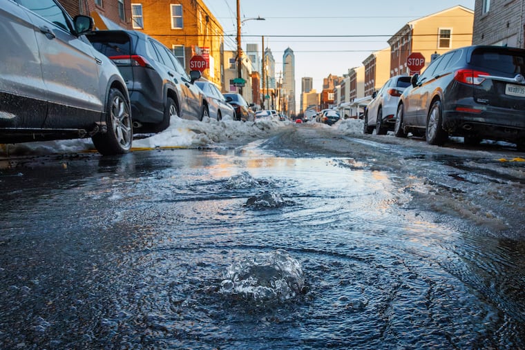 A water main break bubbles up from the middle of South 16th Street just below Federal Street on Wednesday.