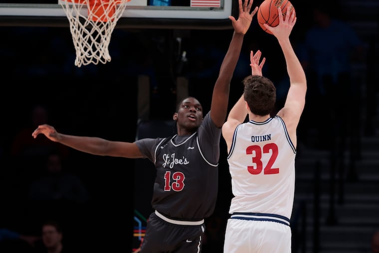Rasheer Fleming, left, of St. Joseph's goes up to try and block a shot by Neal Quinn of Richmond during a quarterfinal game in the Atlantic 10 Basketball Tournament on March 14, 2024.