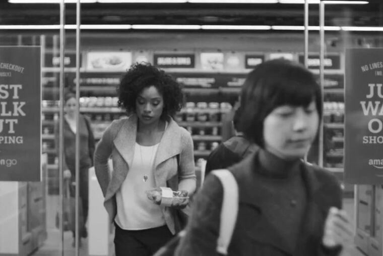 Customers leave an Amazon convenience store after selecting their purchases and being charged for them automatically.