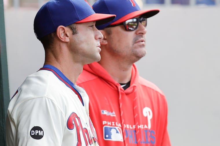 Phillies manager Gabe Kapler (left) with pitching coach Chris Young during Sunday's season finale against the Marlins.
