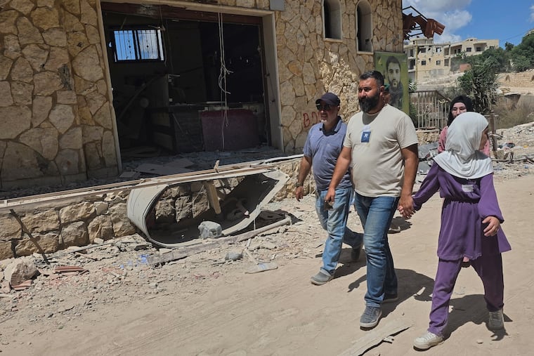 People walk through the village of Zawtar al-Gharbiyeh after the Lebanese army deployed to the village in southern Lebanon, Sunday, July 26, 2026.