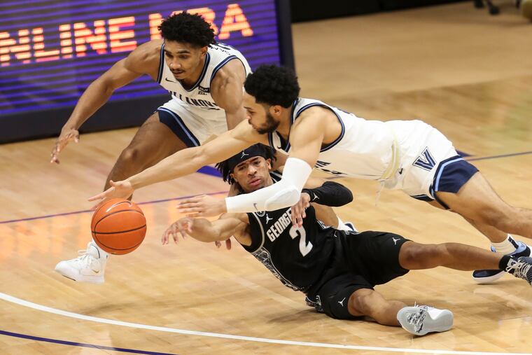 Villanova Wildcats forward Jermaine Samuels (23), Georgetown Hoyas guard Dante Harris (2) and Villanova Wildcats guard Caleb Daniels (14) dive for the ball during the second half of the Villanova Wildcats game against the Georgetown Hoyas at the Finneran Pavilion in Villanova, Pa. on Sunday, February 7, 2021. At the Villanova Wildcats defeated the Georgetown Hoyas 84 to 74.