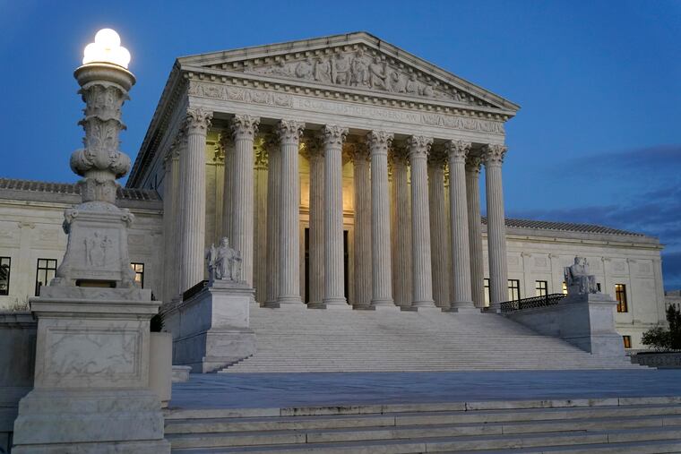 FILE - Light illuminates part of the Supreme Court building at dusk on Capitol Hill in Washington, Nov. 16, 2022. (AP Photo/Patrick Semansky, File)