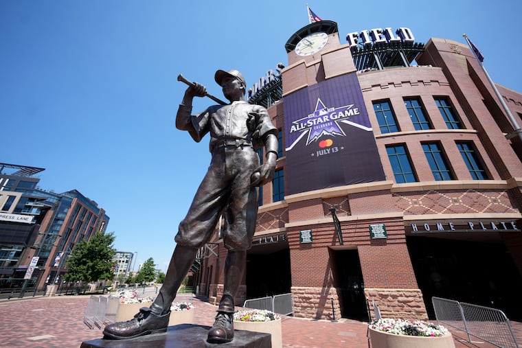 A banner for the All-Star game hangs on the front of Coors Field near the sculpture "The Player." Denver is hosting the Home Run Derby for just the second time since it began in 1985.