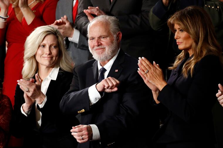 Rush Limbaugh reacts as first Lady Melania Trump, and his wife Kathryn, applaud, as President Donald Trump delivers his 2020 State of the Union address.