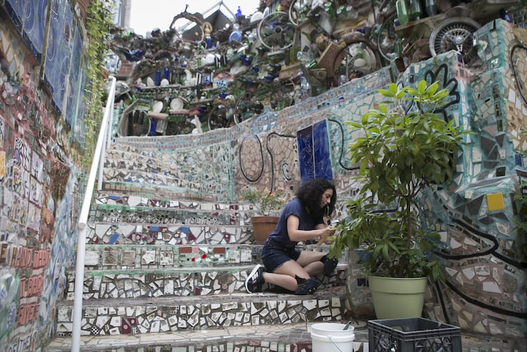 Yaara Ben-Dor removes and restores part of the tiling on the steps of Philadelphia's Magic Gardens on South Street on the morning of Tuesday, July 31, 2018.