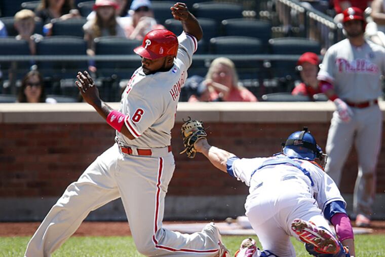 Ryan Howard evades a tag at home by Mets catcher Anthony Recker to score on an RBI single by Domonic Brown during the fourth inning on Sunday, May 11, 2014, in New York. (Jason DeCrow/AP)