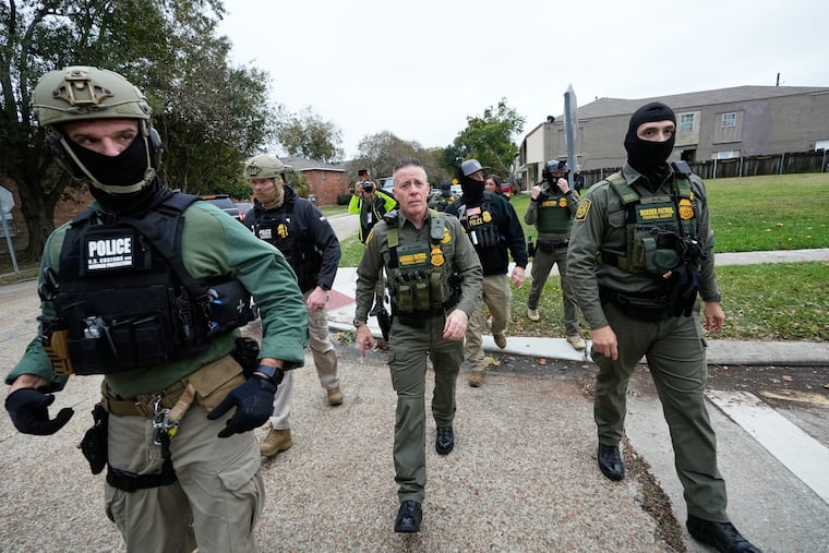 Customs and Border Patrol commander Gregory Bovino walks with border patrol agents through a neighborhood during an immigration crackdown, in Kenner, La., on Dec. 5.