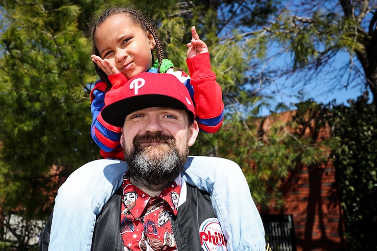 Zack Sminkey and his daughter, Zoe, 5, pose for a portrait outside of Citizens Bank Park on opening day in Philadelphia on Friday.