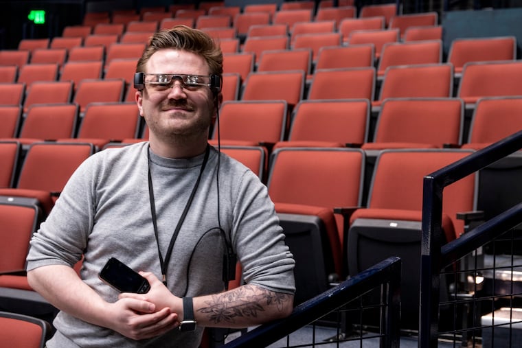 Tanner Richardett, audience services manager at the Arden Theatre, Tuesday, Feb. 13, 2024, demonstrates the smart caption glasses they offer to deaf and hard-of-hearing audiences.
