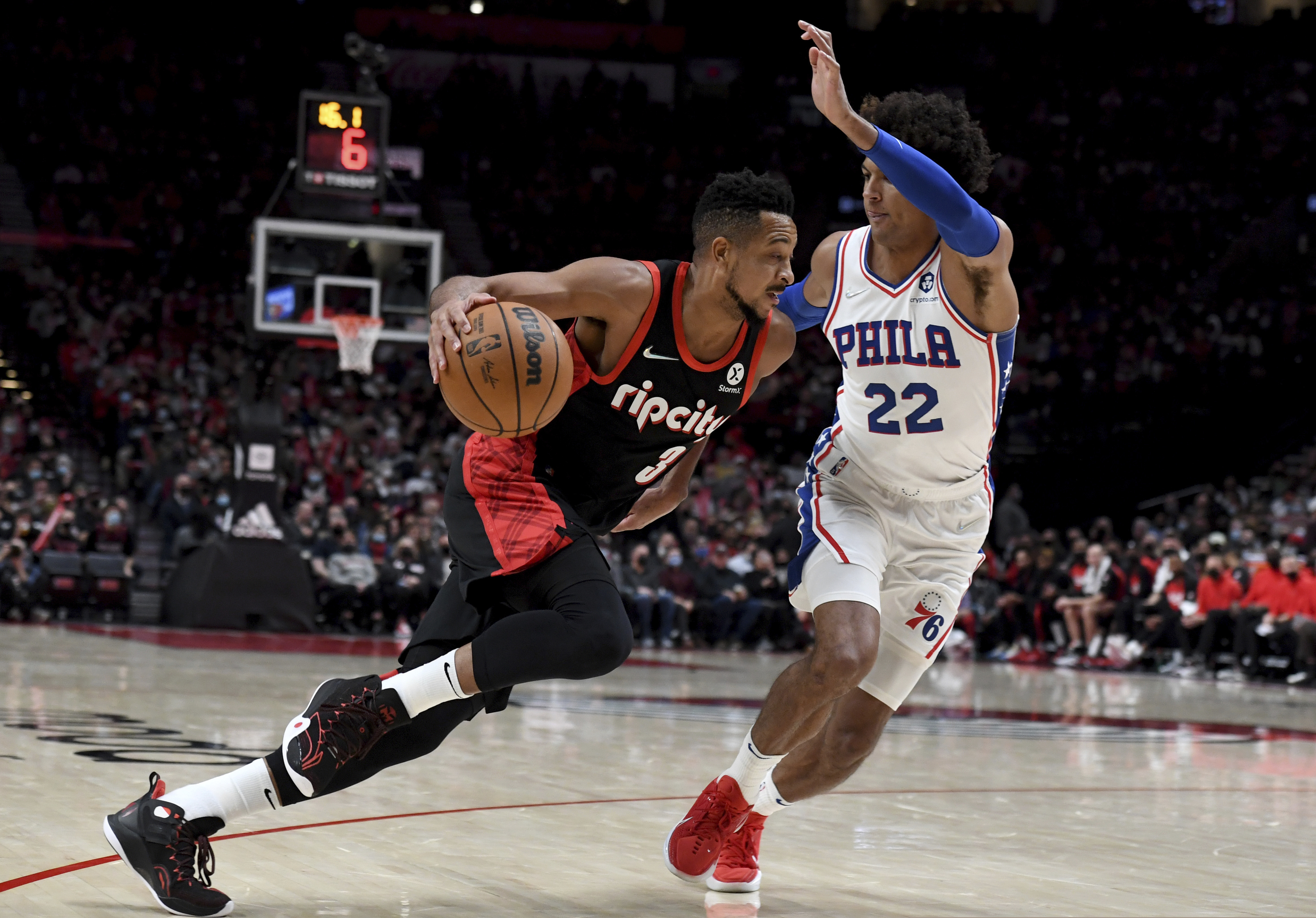 Portland Trail Blazers guard CJ McCollum, left, drives to the basket on 76ers guard Matisse Thybulle, right, during the second half of an NBA basketball game in Portland, Ore., Saturday.