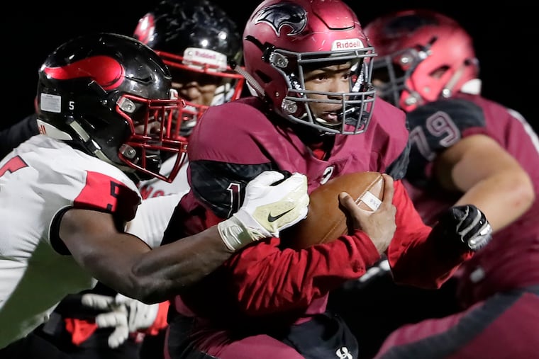 St. Joseph's Prep's Malik Cooper runs for yardage in the Hawks' 43-26 win over Northeast in the Class 6A city title game.