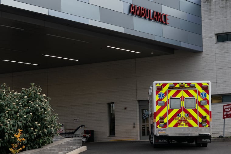 An ambulance drives up to Penn Presbyterian Medical Center in Philadelphia, Thursday, Dec. 3, 2020.