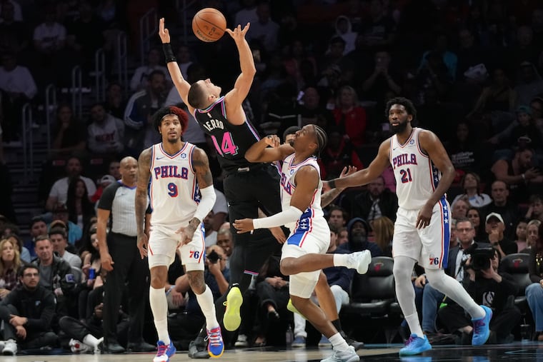 Miami Heat's Tyler Herro (center) loses control of the ball as he's defended Sixers guard Tyrese Maxey on Monday.