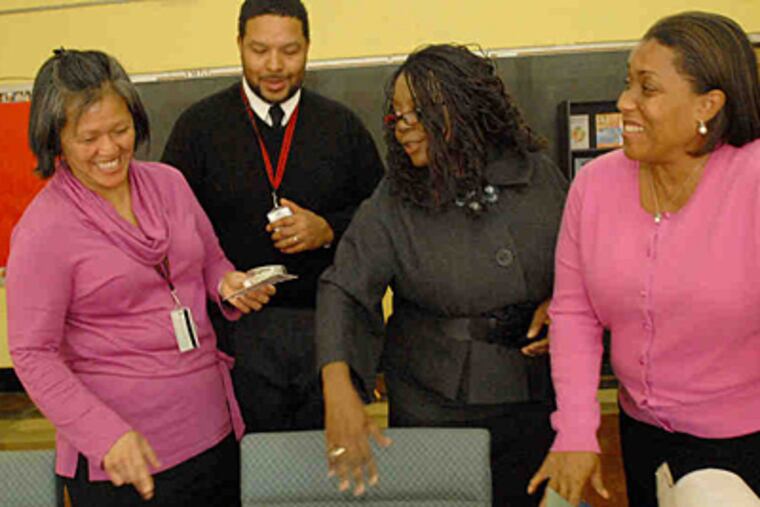 Preparing the new parent resource room at South Philadelphia Highare (from left) vice principal Kim Chek-Taylor, principal Otis Hackney, vice principal Juanita Johnson, and vice principal Cheryl Yancey-Hicks. "We're creating an environment that's more supportive," Hackney said.