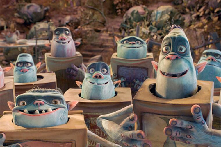 The Boxtrolls are a community of quirky creatures who have raised a human boy beneath the cobblestoned streets of Cheesebridge. (Focus Features)