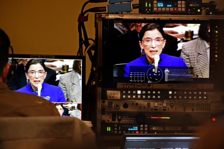 U.S. Supreme Court justice Ruth Bader Ginsburg is seen during her confirmation hearing on mnitors as a video about her plays before she is inducted into the National Museum of American Jewish History's Only in America Gallery.
