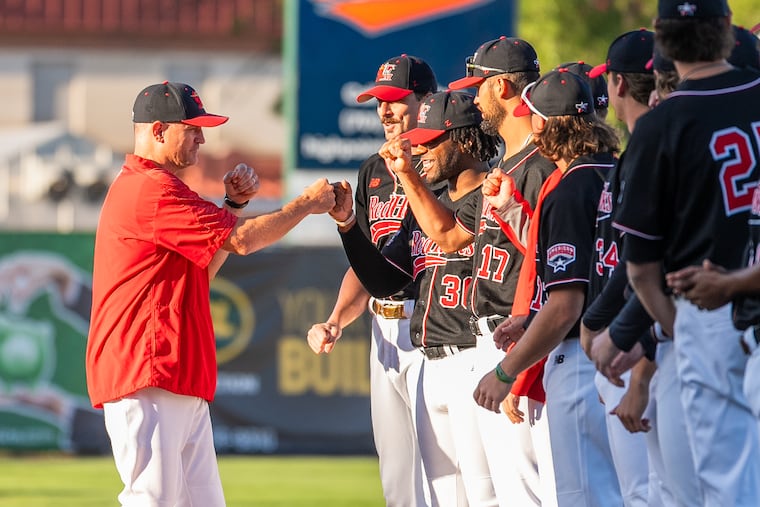 Manager Chris Coste greets his Fargo-Moorhead RedHawks players before a game.