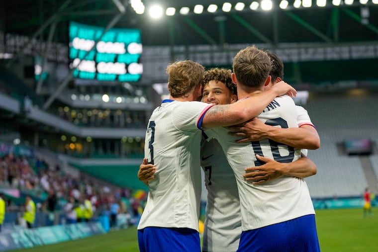 United States' Kevin Paredes (center) celebrates with teammates after scoring his team's third goal of the game.