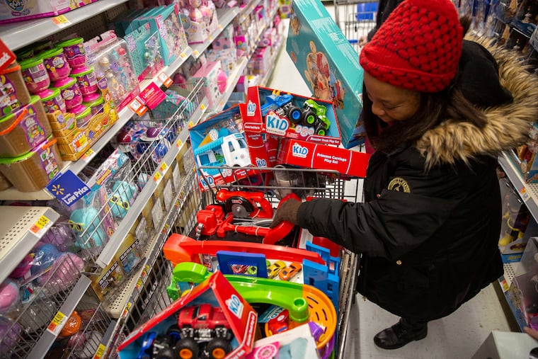 Sharon Woods rummages through a shopping cart at a Philadelphia Walmart Friday. Walmart workers have formed OUR Walmart, which aims to fight for better wages and working conditions.