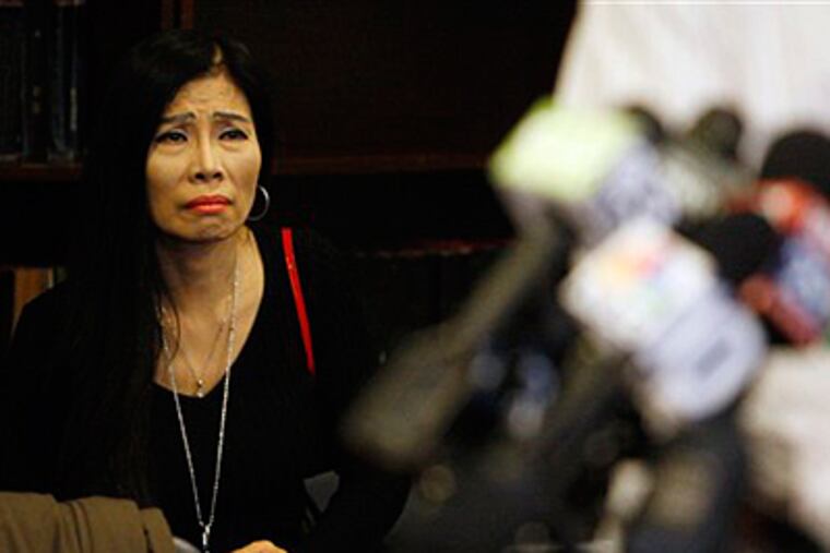 Mabel Chan looks on during a news conference Friday where Chinese students spoke about rising tension at South Philadelphia High School. in Philadelphia. (AP Photo/Matt Slocum)