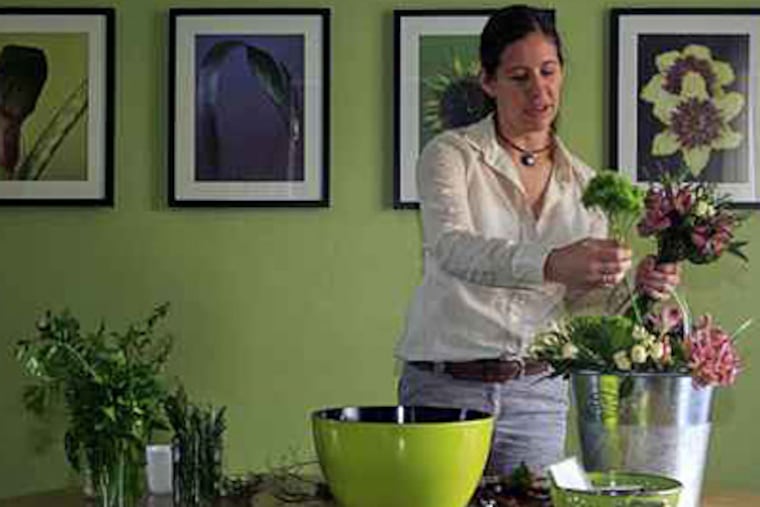 At her floral design business Fleurish, Jane Cespuglio makes a bouquet of gathered flowers and herbs. (Akira Suwa / Staff Photographer)