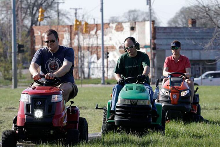"Mower Gang" members (from left) Nathan Labadie, Andrew Haig, and Darton Case tackle Duweke Park