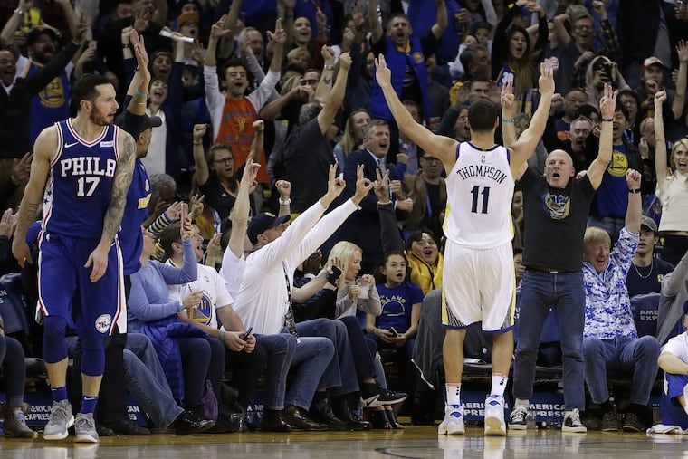 Warriors guard Klay Thompson (right) celebrates during the Sixers’ loss on Saturday.