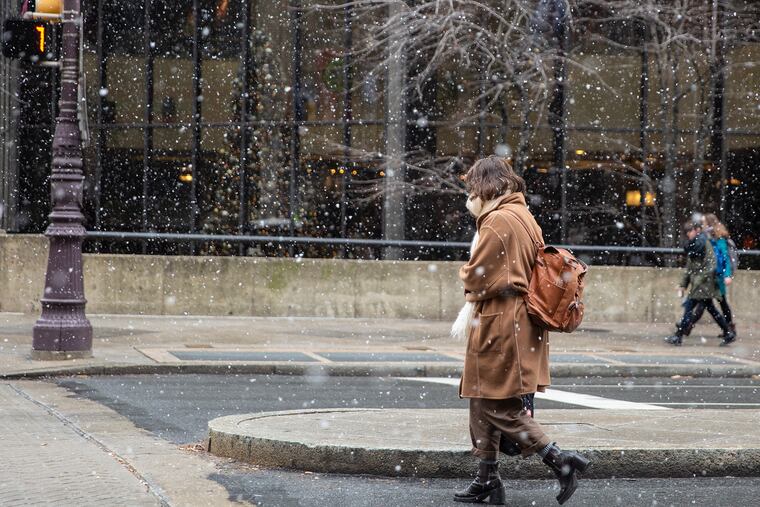 Pedestrians during flake sightings last month; an inch or 2 is possible this weekend.