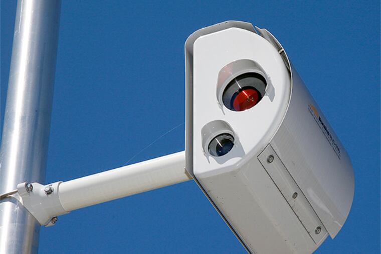 A red light camera is seen on a pole along Franklin Corner Road in Lawrence Township, Wednesday, July, 25, 2012. New Jersey is again giving the green light to red-light cameras. Gov. Chris Christie says all of the cameras have been certified.(AP Photo/Mel Evans)