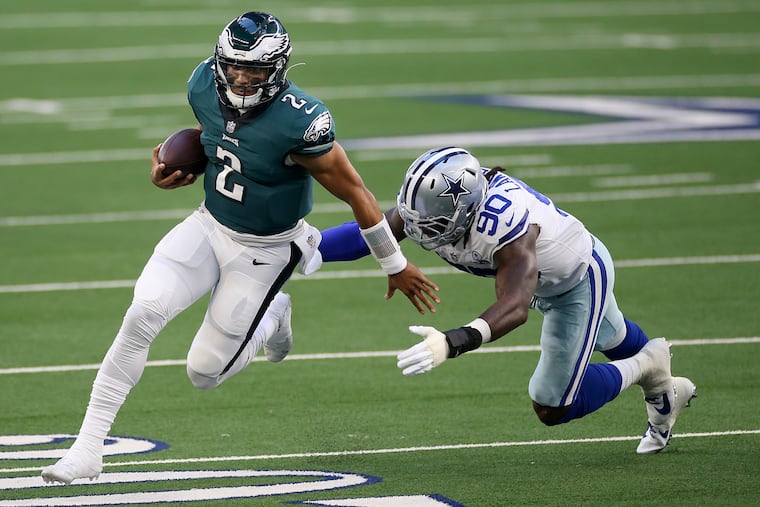 Eagles quarterback Jalen Hurts (left) evades Cowboys defensive end DeMarcus Lawrence in December. The Eagles play the Cowboys in the 2021 regular-season finale. Will it matter?
