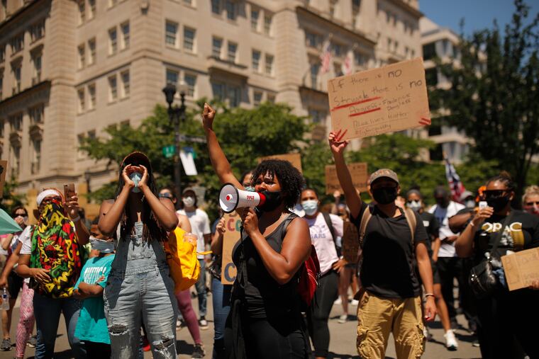Demonstrators protest Sunday, June 7, 2020, near the White House in Washington, over the death of George Floyd, a black man who was in police custody in Minneapolis. Floyd died after being restrained by Minneapolis police officers on Memorial Day.