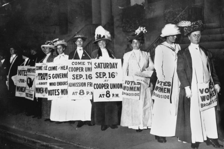 A line of women rally for women's suffrage and advertise a free rally discussing women's right to vote in New York, in Sept. 1916. (AP Photo)