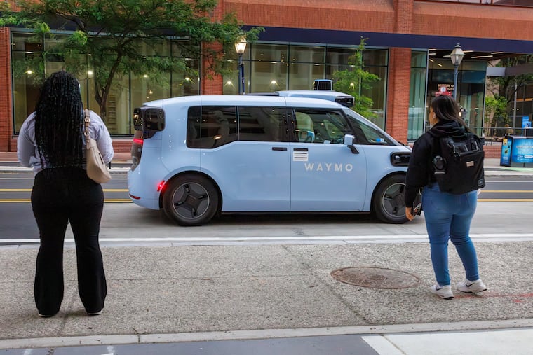 A Waymo driverless car moves along Market Street at Fourth Street in Old City on June 10.