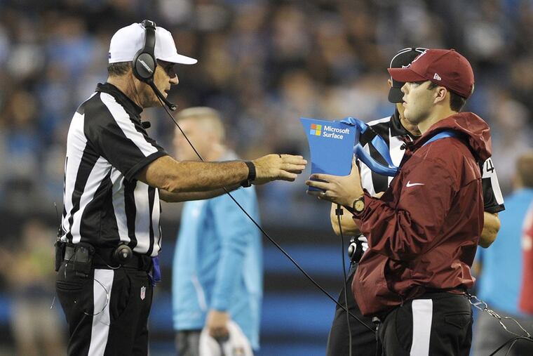 Referee Pete Morelli watches a replay in the second half of an NFL football game between the Carolina Panthers and the Philadelphia Eagles in Charlotte, N.C., Thursday, Oct. 12, 2017.
