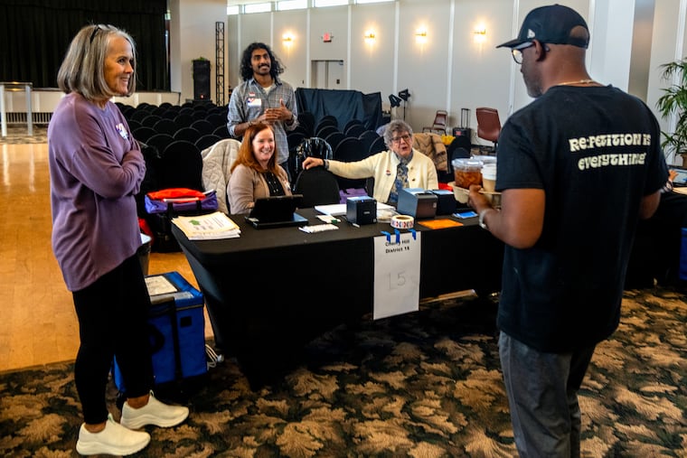 Anthony Robinson, co-owner of Re Cafe, delivers free hot and iced coffee to election workers in Cherry Hill on Tuesday.