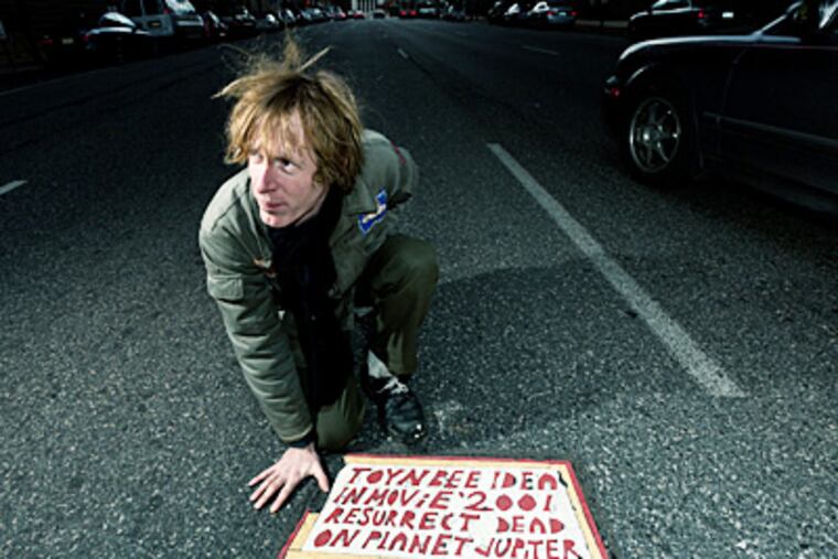 Justin Duerr with a Toynbee tile in a scene from "Resurrect Dead: The Mystery of the Toynbee Tiles." Duerr has been probing the case for years.