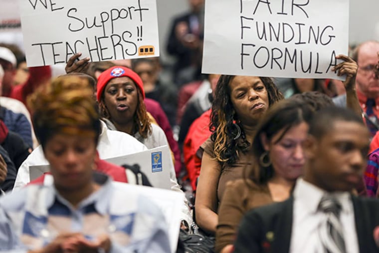 Protesters hold signs during the SRC meeting with new members Bill Green and Farah Jimenez on Thursday, February 20, 2014. ( Steven M. Falk / Staff Photographer )